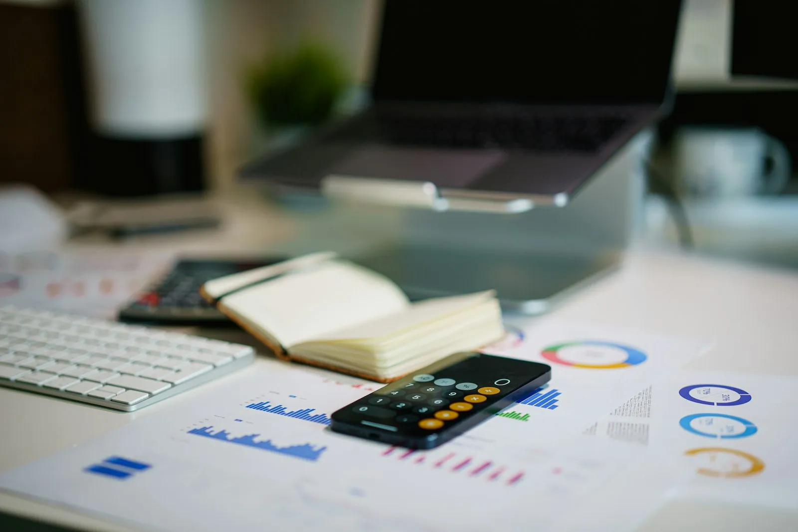 Finanzreport mit Balkendiagrammen und Datentabellen auf einem Schreibtisch, Sinnbild für die Planung eines SEO-Budgets